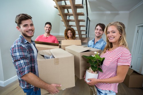 Professional movers handling office equipment during relocation