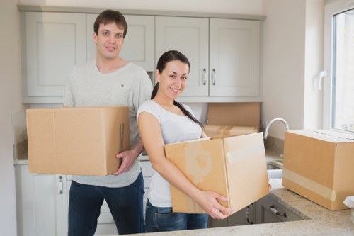 Team of movers efficiently packing office equipment